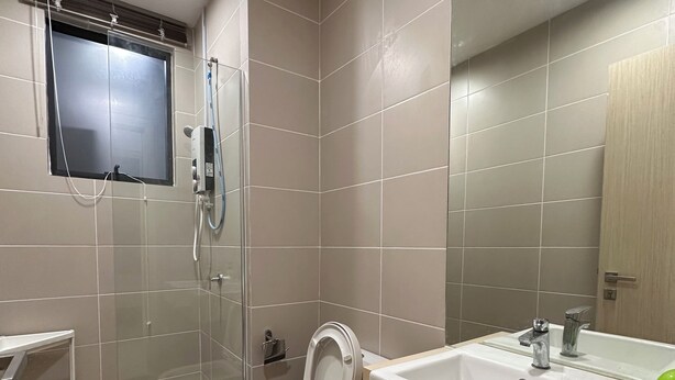 A modern bathroom with a toilet, bidet, and sink. - Stylish Urban Oasis (Petaling Jaya)