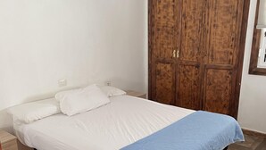 A bedroom with a bed, a wardrobe, and a nightstand. - Tropical Bliss Escape in Costa Adeje (Adeje)