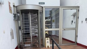 A hotel entrance with a revolving door, a security gate, and a tiled floor. - Tropical Bliss Escape in Costa Adeje (Adeje)