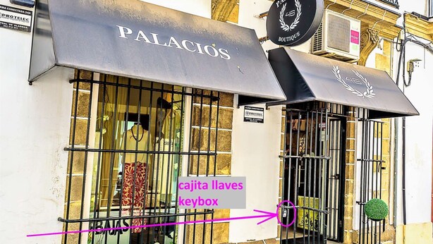 A storefront with a metal gate and a sign reading "PALACIOS BOUTIQUE".
