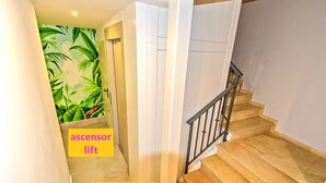 A staircase with a wooden handrail and a low ground floor plant. - Plaza Herrería Central Apartment "D" with Terrace. Right downtown, best location (El Puerto de Santa María)