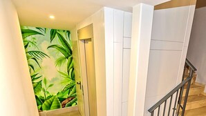 A staircase with a wooden handrail and a low ground floor plant. - Plaza Herrería Central Apartment "D" with Terrace. Right downtown, best location (El Puerto de Santa María)
