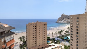 A coastal hotel with multiple floors, a beach view, and a rocky outcrop in the background. - FLORIDA sea view apartment (Benidorm)