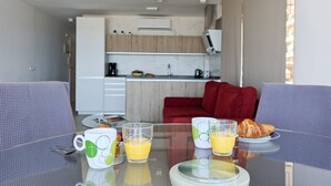 A modern kitchen with a dining area. - ESMERALDA sea front apartment (Benidorm)