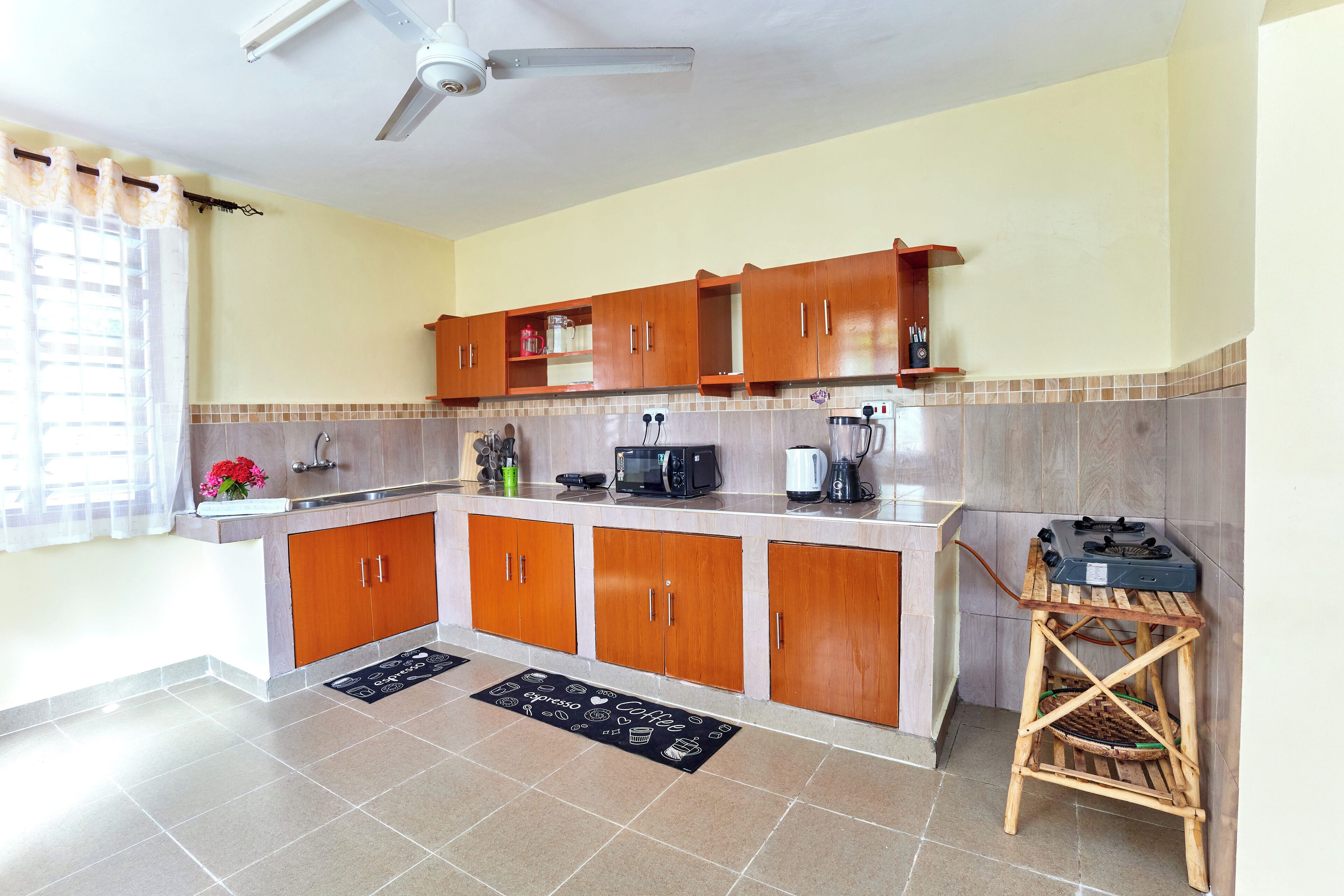 A kitchen with wooden cabinets, a microwave, and a coffee maker.