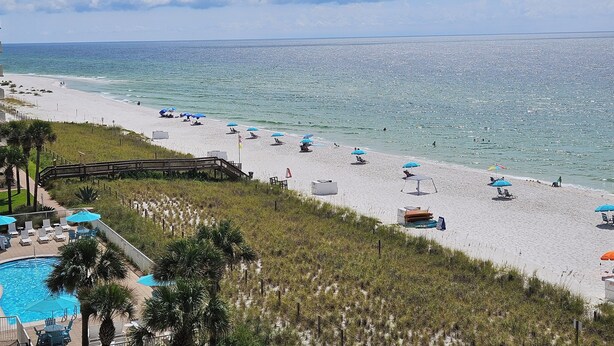 A beach with umbrellas, lounge chairs, and a pool area. - Sandy Key 433: 2 BR / 2BA Gulf Front Condo In Perdido Key, FL. Sleeps 6 (Pensacola)