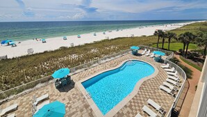 A pool area with lounge chairs and umbrellas, a beach with umbrellas and sun loungers, and a clear view of the ocean. - Sandy Key 433: 2 BR / 2BA Gulf Front Condo In Perdido Key, FL. Sleeps 6 (Pensacola)