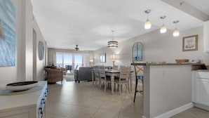 A spacious kitchen with a dining area, a large island, and a view to the outside. - Sandy Key 433: 2 BR / 2BA Gulf Front Condo In Perdido Key, FL. Sleeps 6 (Pensacola)