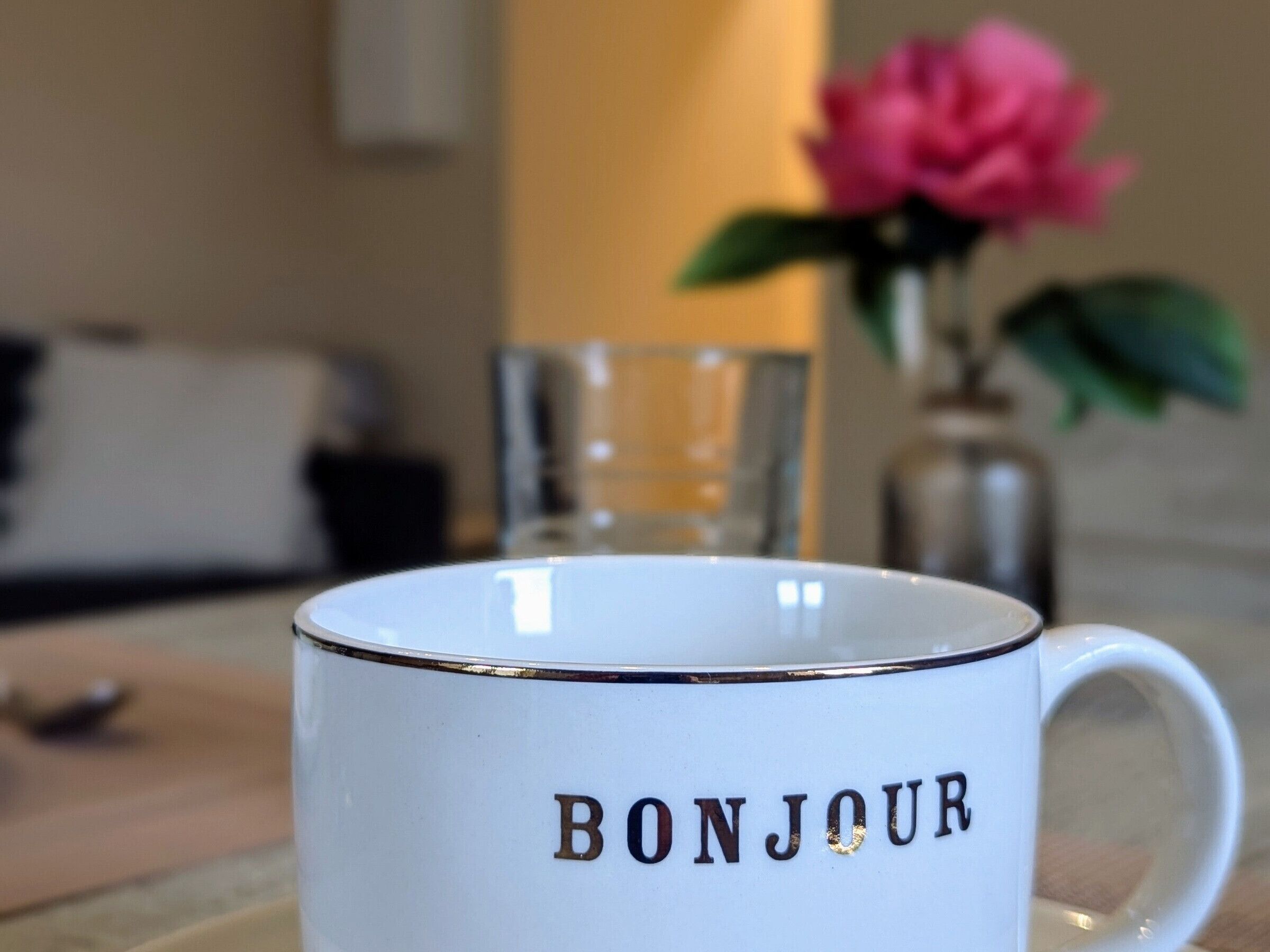 A white mug with the word "BONJOUR" printed on it.