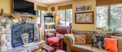 Flat-screen TV, fireplace, books