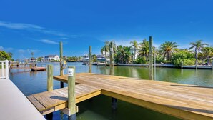 A wooden dock extending into calm water with a clear sky. - Walk to Beach! Waterfront Hudson Townhome (Hudson)