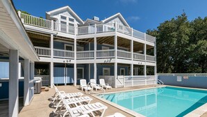 A two-story building with a pool, outdoor seating, and a 'No Diving' sign. - 12BR Retreat w/ Private Pool, Theater, Volleyball + Elevator | Perfect for Large Groups (Corolla)