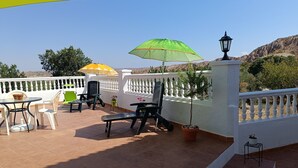 A terrace with outdoor seating, a lamp post, and potted plants. - The Terrance Principle Asturias 15 (Guadix)