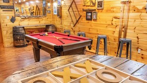 A wooden interior with a pool table, shuffleboard, and a billiards table. - *Gorgeous 3BD Cabin w/ VIEWS! Hot Tub + Fire Pit!* (Sevierville)