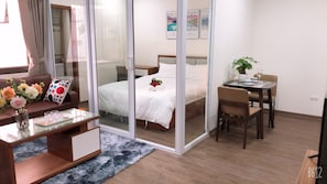 Standard Apartment | Living area | 40-inch flat-screen TV with cable channels, streaming services - HT Home Dao Tan (Hanoi)