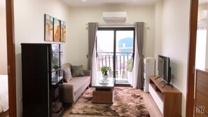 Family Apartment, City View | Living area | 40-inch flat-screen TV with cable channels, streaming services - HT Home Dao Tan (Hanoi)