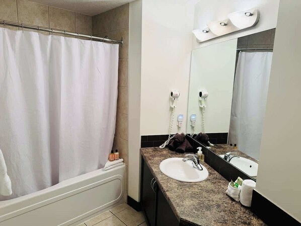 Shower, hair dryer, towels, shampoo