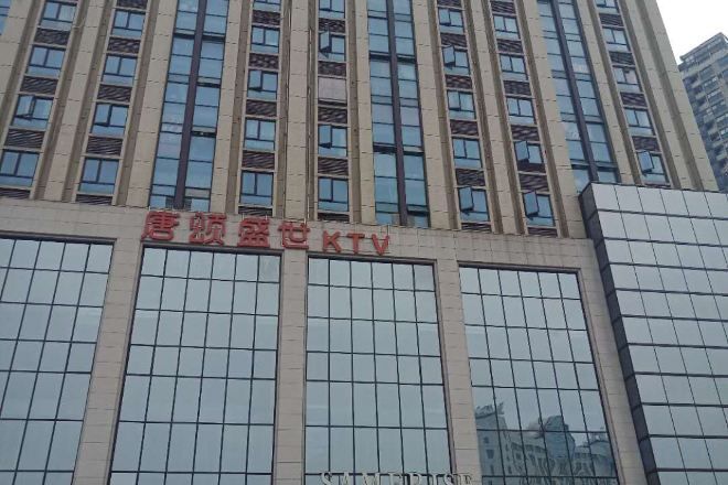A building with multiple floors and a sign that reads 'CCTV' in red letters.