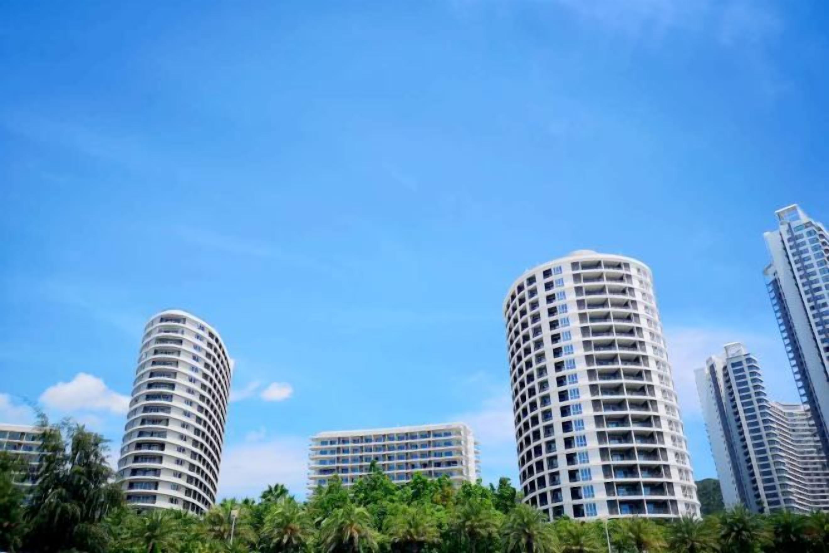 A cluster of high-rise buildings with a clear blue sky.