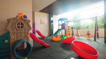 A children's play area with slides and swings.