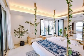 A modern bedroom with a large bed, a potted plant, and a view of the outdoors. - Aizhihai (Beihai)