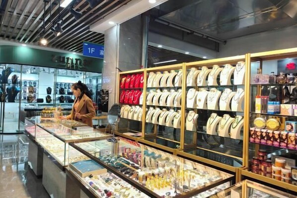 A jewelry store with glass display cases and shelves of jewelry. - Xiyu International Hotel (Urumqi)