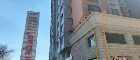 A tall building with a sign indicating a residential area.