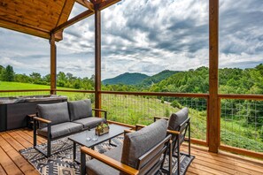 A covered outdoor seating area with a view of a mountainous landscape. - Mountain Views+Hot Tub+Fire Pit+4 Mi to Pigeon Forge (Sevierville)