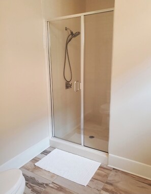 Shower, hair dryer, towels, toilet paper
