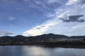 A bridge over a body of water with mountains in the background. - Beginner's Mind in Dali Art Theme Hotel (Dali City)