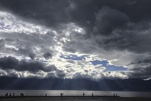 A body of water with a cloudy sky above.
