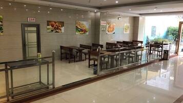 A clean, modern restaurant with a long counter and multiple tables.
