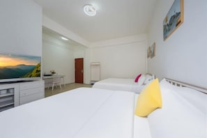 A hotel room with two beds, a desk, and a TV. - Nongzai Guesthouse (Sanya Wuzhizhou Island Houhai) (Sanya)