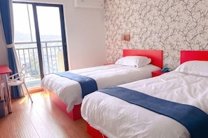 A hotel room with two beds, a balcony, a chair, and a patterned wall.