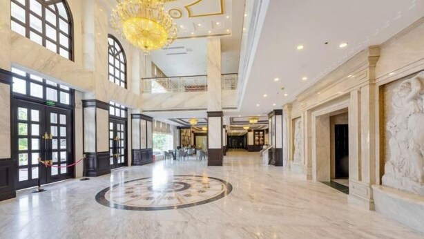 A spacious lobby with marble floors, large windows, and a grand chandelier. - Light Grand Hotel (Fengdu County)