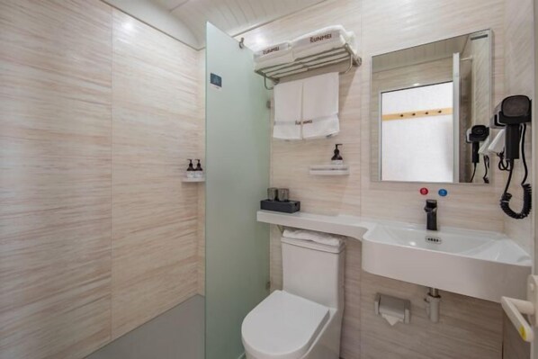A modern bathroom with a toilet, sink, mirror, and hairdryer. - Shankee Hotel (Qixia Commercial Street Moushi Manor) (Qixia)