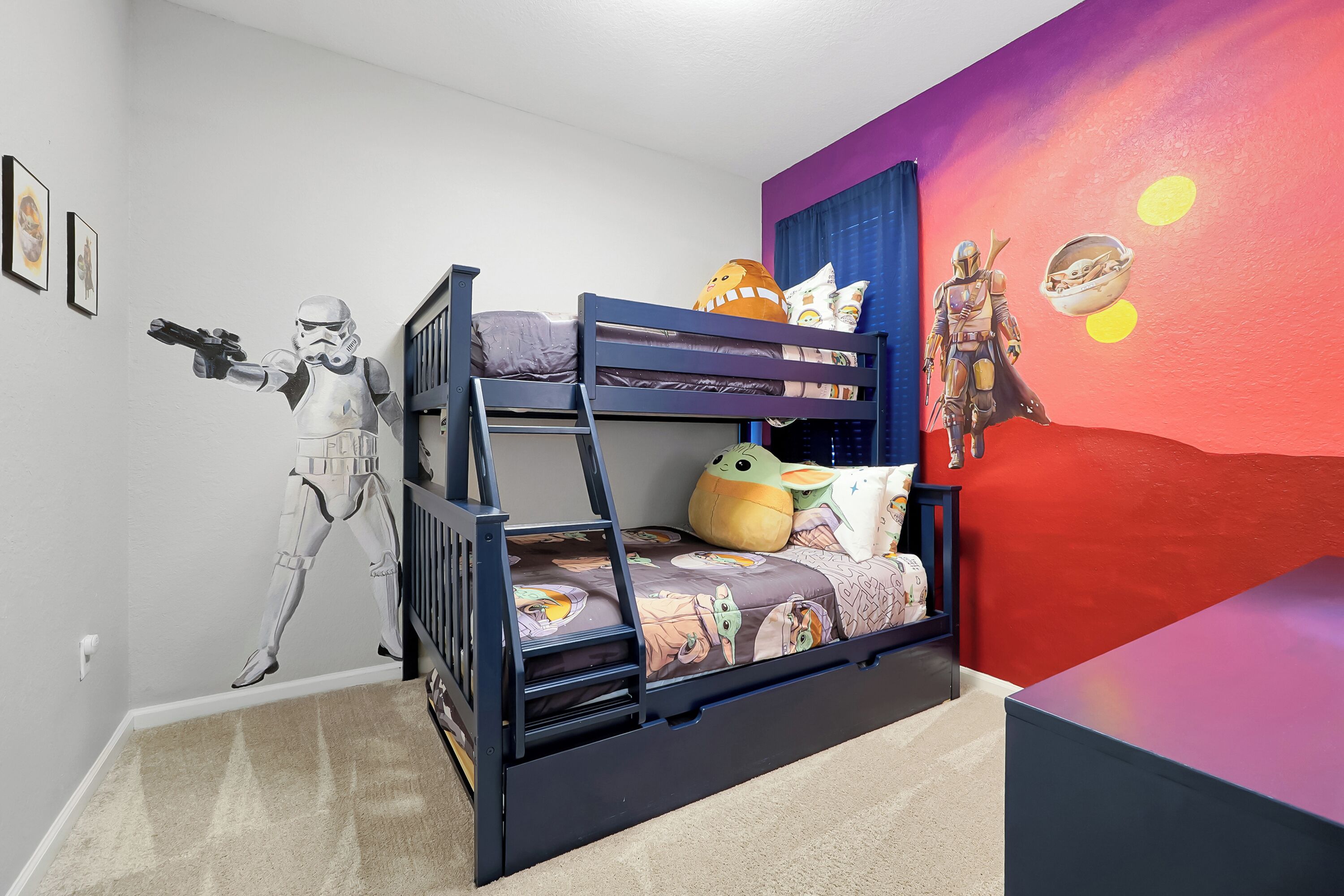 A bunk bed with a Star Wars-themed mural, a Star Wars action figure, and a plush toy.