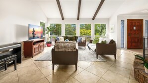 A spacious living room with a large window, a fireplace, and a piano. - Russian River Wine Country Retreat Near Healdsburg: Pool, AC & EV Charger (Forestville)