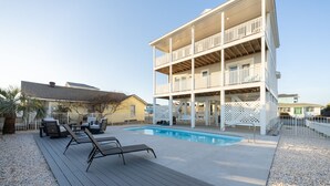 A multi-story building with a pool, outdoor seating, and a deck. - 🌊 Luxe Oceanfront Escape 4BR + Private Pool & Stunning Views (Holden Beach)