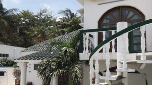 A white building with a balcony, a pool, and potted plants. - Casa, "Joy of the Sea" (Puerto Morelos)