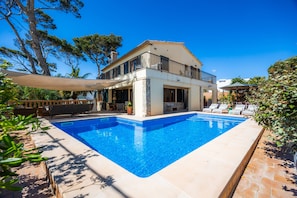 A two-story house with a swimming pool, outdoor seating, and a covered patio. - Spacious Villa by the Sea with Private Saltwater Pool (Can Pastilla)