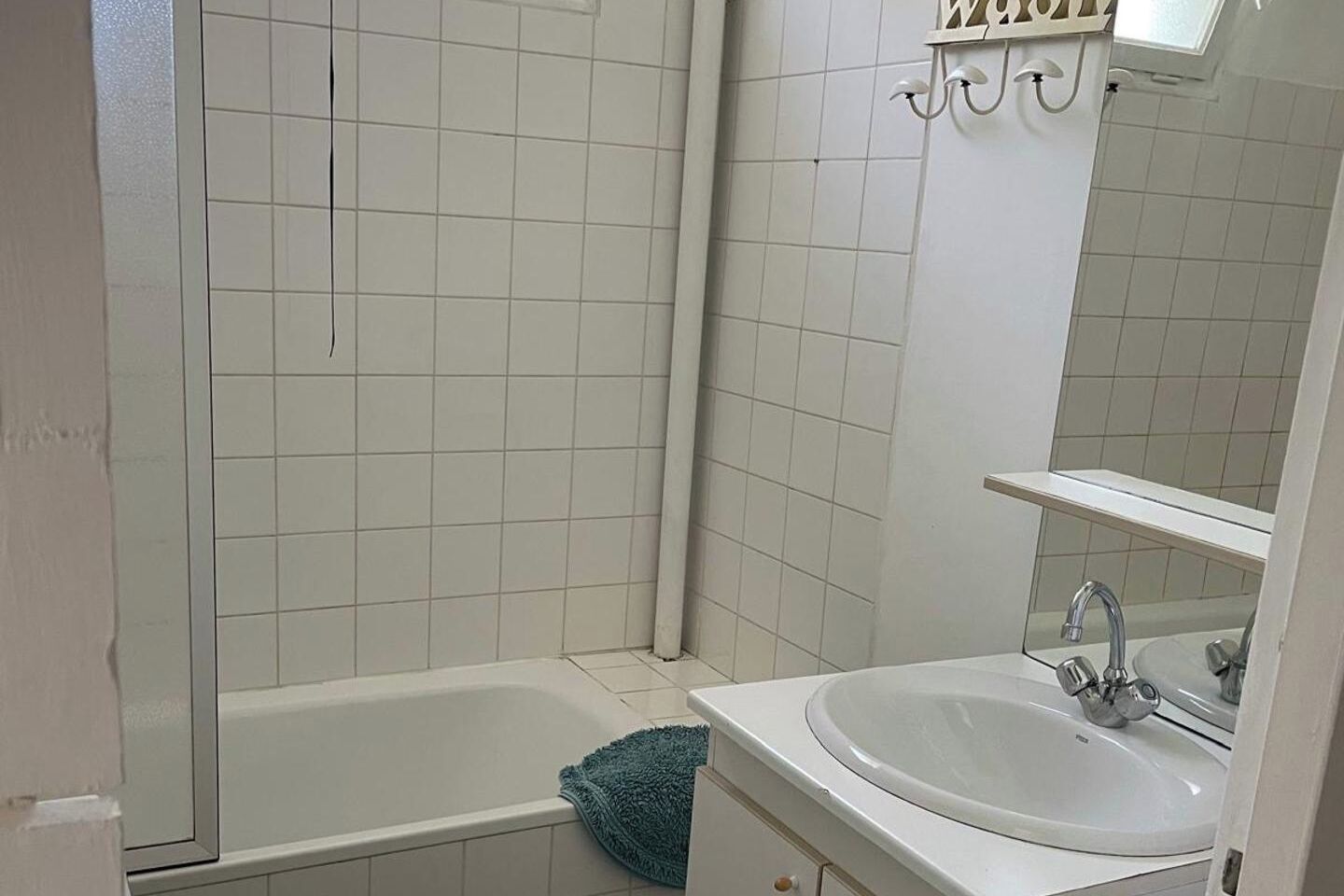 A bathroom with a bathtub, a sink, and a shower.