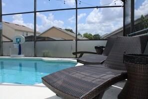 Relax by the clear pool surrounded by lounge chairs and take in the view.