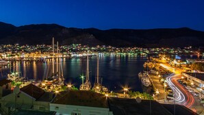 A coastal town at night with a marina, boats, and a mountainous backdrop. - Maria House in the port of Kalymnos (Kalymnos)