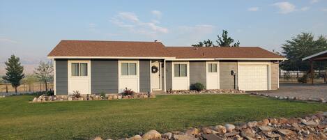 A single-story house with a garage, a front porch, and a well-maintained lawn.