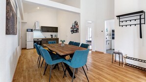 A modern kitchen with white cabinets, a microwave, and a refrigerator.