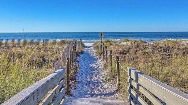 A wooden boardwalk leading to a beach with a clear blue sky. - STEPS to Beach! 2B/2B, Sleeps 9! Beach, POOL, Repeat! NEW! Grill! Wagon! (Panama City Beach)