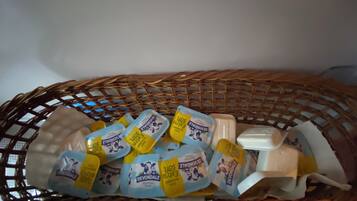 A wicker basket containing several packages of Devondale soap and a bar of soap.