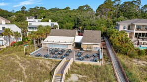 A beachfront property with a covered patio area, a pool, and a staircase leading down to the beach. - Pet-Friendly Palmetto Dunes House Walk to Beach & Golf (Hilton Head Island)