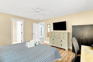 A bedroom with a bed, dresser, TV, and a ceiling fan. - Pet-Friendly Palmetto Dunes House Walk to Beach & (Hilton Head Island)